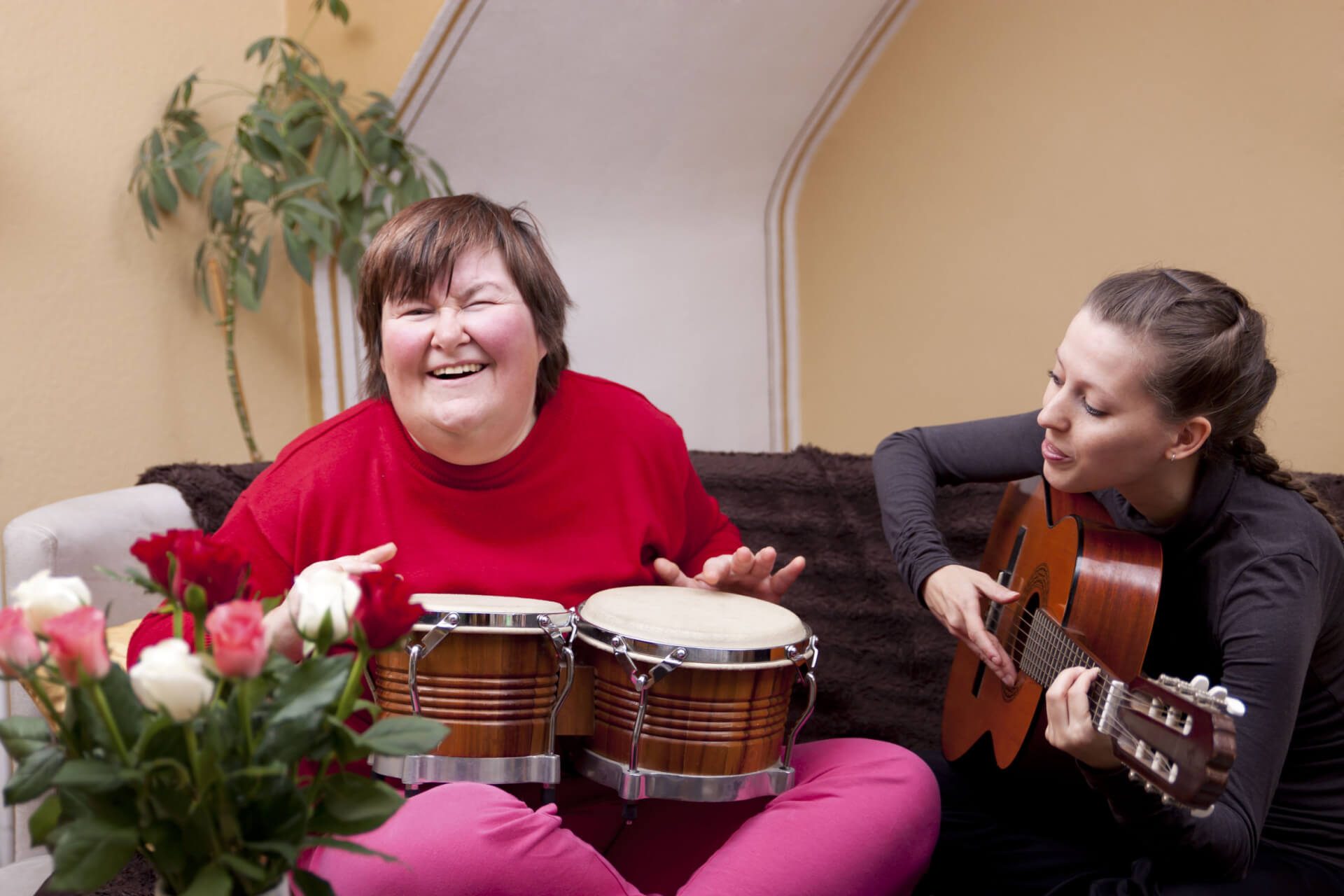 Two women doing music therapy and having fun