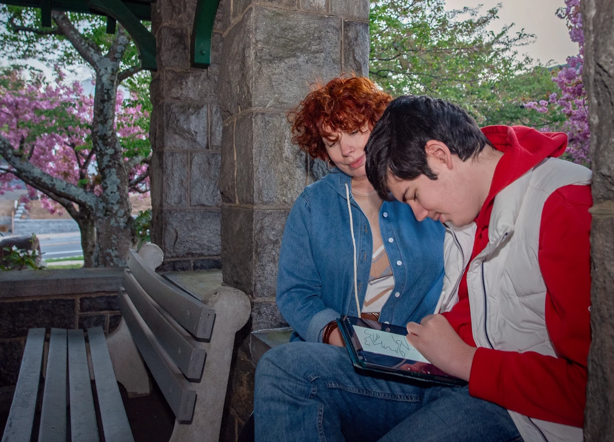 Two people sitting on a bench